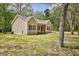 Side view of the home featuring light siding, a gray roof, and a well-maintained yard at 2857 Greenbrook Dr, Wendell, NC 27591