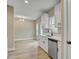 Bright eat-in kitchen features white cabinets, stainless steel appliances, and wood flooring at 2857 Greenbrook Dr, Wendell, NC 27591