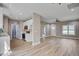Open-concept kitchen and living room with stainless appliances and modern lighting at 2857 Greenbrook Dr, Wendell, NC 27591