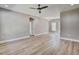 Spacious living room with modern ceiling fan, and light wood-look flooring at 2857 Greenbrook Dr, Wendell, NC 27591