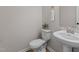 Clean powder room with pedestal sink and toilet at 320 Shore Pine Dr, Youngsville, NC 27596