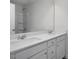 Bathroom with a double sink vanity, a large mirror, and a shower with a glass door and tiled walls at 34 Fairwinds Dr, Lillington, NC 27546