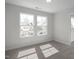 Bright bedroom featuring two windows that offer abundant natural light and neutral wall and floor color palette at 34 Fairwinds Dr, Lillington, NC 27546
