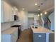 Modern kitchen with white cabinets, stainless steel appliances, and a functional center island with a sink at 34 Fairwinds Dr, Lillington, NC 27546