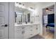 This primary bath features double sinks, a glass-enclosed shower, and modern lighting at 404 Andrews Rd, Durham, NC 27705