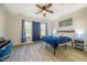 This bedroom features a ceiling fan, natural light, and wood-look floors at 404 Andrews Rd, Durham, NC 27705