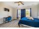 This bedroom features a ceiling fan, natural light, and wood-look floors at 404 Andrews Rd, Durham, NC 27705
