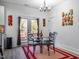 This dining area features a glass table, seating for four, and natural light at 404 Andrews Rd, Durham, NC 27705