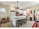 Modern kitchen featuring stainless steel appliances, a central island with seating, and sleek white cabinetry at 404 Andrews Rd, Durham, NC 27705