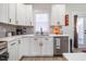 This kitchen features white cabinets and quartz countertops, accented by stainless steel appliances at 404 Andrews Rd, Durham, NC 27705