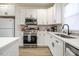 Stylish kitchen featuring stainless steel appliances, white cabinetry, and a functional design at 404 Andrews Rd, Durham, NC 27705
