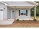 Inviting front porch with light blue door and landscaping at 435 Iris Bryant Rd, Dunn, NC 28334
