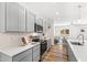 Modern kitchen with gray cabinets, quartz countertops, and stainless steel appliances at 435 Iris Bryant Rd, Dunn, NC 28334