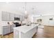 Open concept kitchen with island, gray cabinets, and stainless steel appliances at 435 Iris Bryant Rd, Dunn, NC 28334