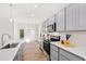 Open kitchen boasts gray cabinets, quartz countertops, and stainless steel appliances at 435 Iris Bryant Rd, Dunn, NC 28334
