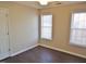 Bedroom with two windows, wood flooring, and ceiling fan at 5016 Parkerwood Dr, Knightdale, NC 27545