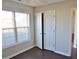 Bedroom with double door closet and large window at 5016 Parkerwood Dr, Knightdale, NC 27545