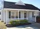 Gray house with a black roof, white porch railings, and well-manicured bushes at 5016 Parkerwood Dr, Knightdale, NC 27545