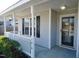 Front porch with white railings and a view of the front yard at 5016 Parkerwood Dr, Knightdale, NC 27545
