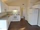 White cabinets, dark floors, and a spacious layout highlight this kitchen at 5016 Parkerwood Dr, Knightdale, NC 27545