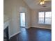 Living room with hardwood floors, fireplace and access to back deck at 5016 Parkerwood Dr, Knightdale, NC 27545