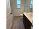 Well-lit bathroom featuring a tub-shower and wood-look flooring at 524 Gainer Dr # 7, Raleigh, NC 27610