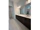 Elegant bathroom featuring a double sink vanity with sleek, dark wood cabinets and light countertops at 524 Gainer Dr # 7, Raleigh, NC 27610