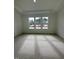 Bedroom featuring carpet, neutral paint, and an abundance of natural light from large windows at 524 Gainer Dr # 7, Raleigh, NC 27610