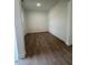 Bright bedroom featuring wood laminate flooring, clean white walls, and ample natural light at 524 Gainer Dr # 7, Raleigh, NC 27610