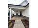 A covered front entrance with brick accents, a modern dark door and ample space at 524 Gainer Dr # 7, Raleigh, NC 27610