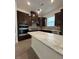 Modern kitchen with granite countertops, dark cabinets, and stainless steel appliances at 524 Gainer Dr # 7, Raleigh, NC 27610