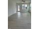 Open concept living room with laminate flooring, neutral paint and an exit to the yard at 524 Gainer Dr # 7, Raleigh, NC 27610