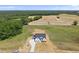 Aerial view of a charming new construction farmhouse with black shutters at 5377 River Buck Rd, Spring Hope, NC 27882