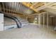 Unfinished attic with exposed beams, plywood flooring, and insulation installed at 5377 River Buck Rd, Spring Hope, NC 27882