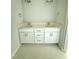 Bathroom featuring a double vanity with white cabinets, light fixtures, and tile flooring at 5377 River Buck Rd, Spring Hope, NC 27882