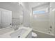 Clean bathroom features a vanity with a white countertop, a framed mirror and shower-tub combo at 5377 River Buck Rd, Spring Hope, NC 27882