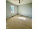 Bright bedroom features a ceiling fan and a window with neighborhood views at 5377 River Buck Rd, Spring Hope, NC 27882