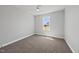Neutral bedroom with plush carpet, ceiling fan, and ample natural light from the window at 5377 River Buck Rd, Spring Hope, NC 27882
