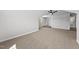 Expansive bonus room featuring a ceiling fan, plush carpet, and bright windows with natural light at 5377 River Buck Rd, Spring Hope, NC 27882