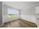 Bright dining room featuring hardwood floors, elegant chandelier, and large window with scenic views at 5377 River Buck Rd, Spring Hope, NC 27882