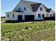 A wide view shows the large back of this new construction home with a spacious three car garage at 5377 River Buck Rd, Spring Hope, NC 27882