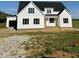A charming new home with black shutters and bright white siding sits on a spacious lot at 5377 River Buck Rd, Spring Hope, NC 27882