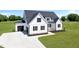 Beautiful new construction farmhouse featuring a two-car garage and concrete driveway at 5377 River Buck Rd, Spring Hope, NC 27882