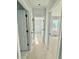 Hallway with neutral paint, white trim, and doors leading to various rooms at 5377 River Buck Rd, Spring Hope, NC 27882