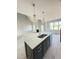 Open concept kitchen with a large black island, quartz counters, and pendant lighting at 5377 River Buck Rd, Spring Hope, NC 27882