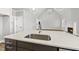 Modern kitchen with quartz counters, stainless steel sink, and open view to the living room with fireplace at 5377 River Buck Rd, Spring Hope, NC 27882
