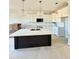Modern kitchen with white cabinets, black island, quartz counters, and stainless steel appliances at 5377 River Buck Rd, Spring Hope, NC 27882