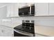 Contemporary kitchen features stainless steel appliances, white subway tile backsplash, and quartz countertops at 5377 River Buck Rd, Spring Hope, NC 27882