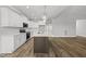 New kitchen with white cabinets, stainless appliances, island, and open to the dining and living area at 5377 River Buck Rd, Spring Hope, NC 27882