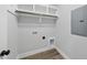 Bright laundry area with built-in shelves, rod, and modern connections, perfect for efficient home management at 5377 River Buck Rd, Spring Hope, NC 27882